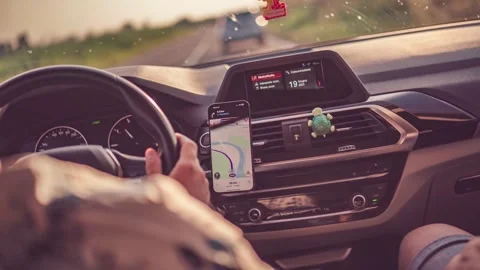 Woman driving car using gps navigation on smartphone Stock Footage 311754752