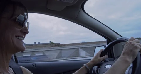 Woman driving car while bouncing to music close up Stock Footage 118548251