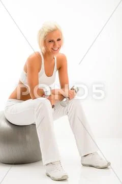 Woman with dumbbells relax on fitness ball Stock Photos