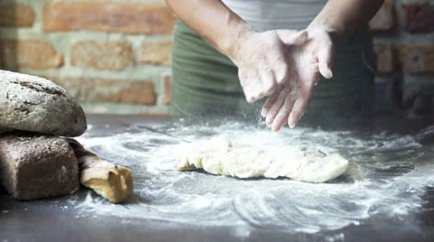 Woman dusting off the flour from her palms, slow motion at 60 fps Stock Footage