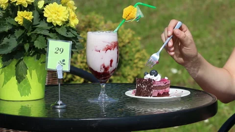 Woman eat blueberry cake in summer restaurant garden Stock Footage