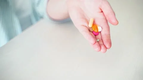 Woman eat pregnancy pills. Flu supplements. Taking allergy drugs. Medical fish Stock Footage 166604541