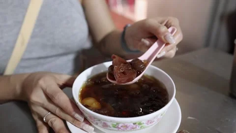 Woman Eating Assorted Beans in Syrup at Bangkok Street Food Stall Stock Footage 317599298