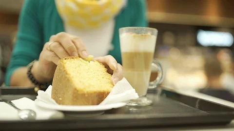 Woman eating cake in the cafe and relaxing, steadycam shot Stock Footage