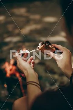 Woman eating cheese filled biscuit sandwich Stock Photos