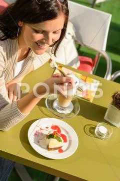 Woman eating cheesecake at cafe bar happy Stock Photos
