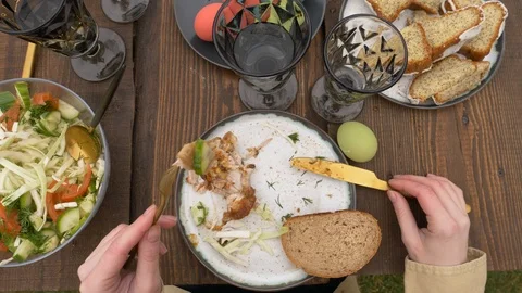 Woman eating during Easter dinner Stock Footage 122540766