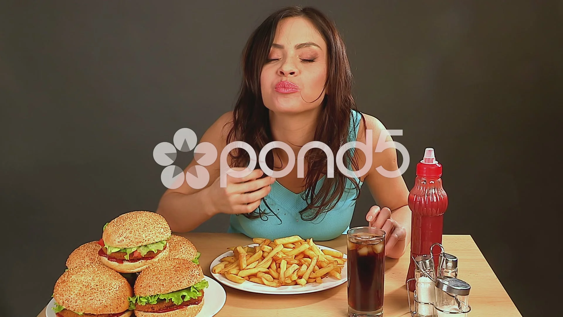 Woman eating fast food.Time lapse