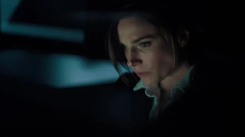 Woman Eating in front of a computer Screen in the Dark Stock Footage 254763334
