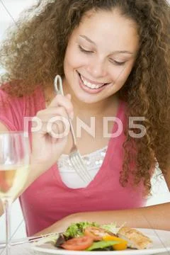 Woman eating meal,mealtime with a glass of wine Stock Photos