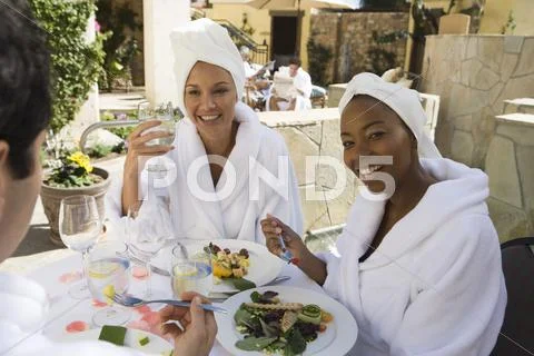Woman Eating Organic Meal With Friends Stock Photos