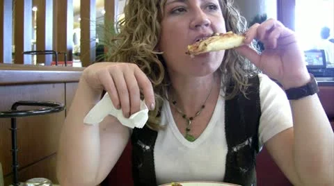 Woman eating pizza Stock Footage