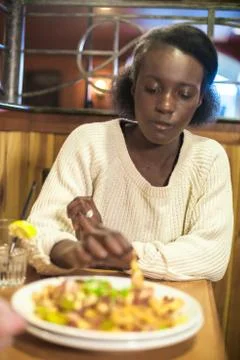 Woman Eats Appetizer at Dinner Stock Photos
