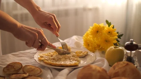 Woman eats Breakfast with scrambled eggs using fork and knife Stock Footage 126479435