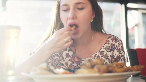 A woman eats at a cafe. Stock Footage 90313065