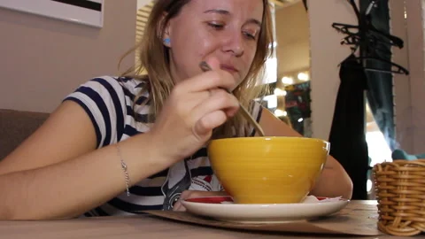 Woman eats in a cafe Stock Footage 92192576