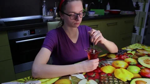 Woman eats cherry jelly in the kitchen Stock Footage 146165849