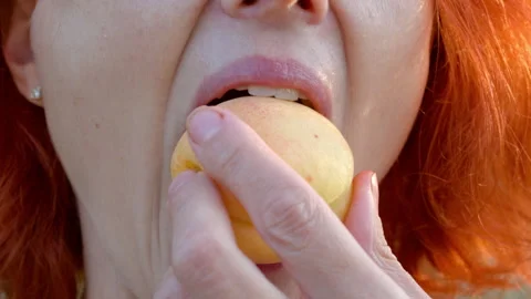A woman eats a fresh apricot. Stock Footage 329631404
