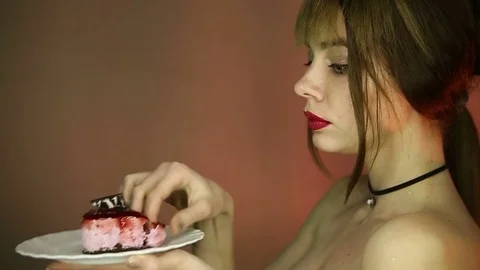 The woman eats her cake with ears Stock Footage