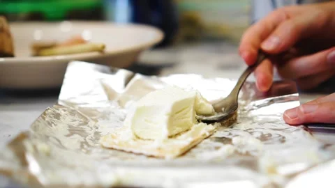 A woman eats ice cream with a spoon that lies on the wrapper. Close-up shooting Stock Footage 319830956