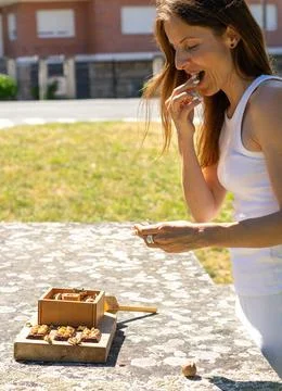 Woman eats nuts Stock Photos