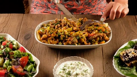 Woman eats oriental dish, meat with vegetables and peas Stock Footage 283726148
