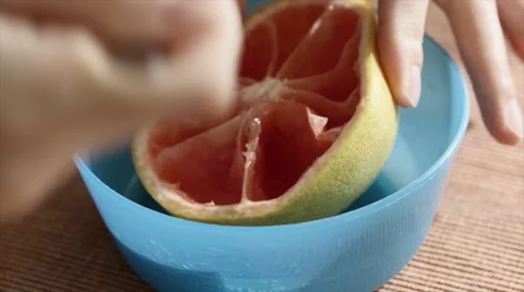 Woman eats a red grapefruit for breakfast Video stock 46945861
