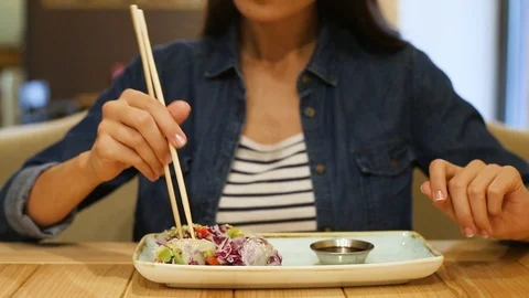 Woman eats vegan rolls in cafe Stock Footage 97111297