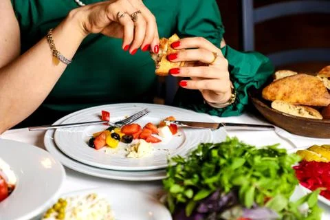 Woman eats vegetable salad with bread Stock Photos