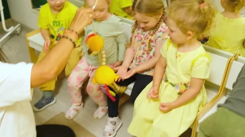 Woman educator playing with children using handmade toy in preschool class... Stock Footage 333563878
