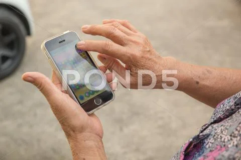 Woman Elderly Using A Smart Phone.