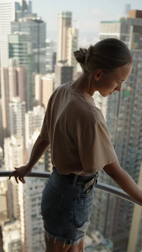 Woman in elevator in the skyscraper of HongKong with the view of city panorama Stock Footage 297735154