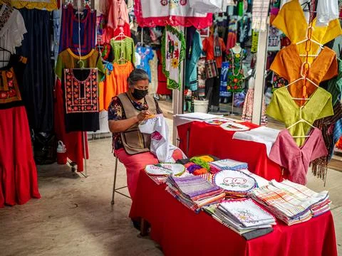 A woman embroidering a pattern at the bazaar Stock Photos