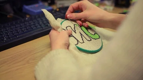 Woman embroiders with a needle and thread Stock Footage 73203025