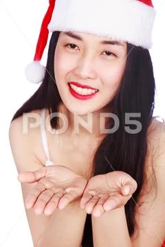 Woman with empty blank palm hand in Santa Claus clothes isolated on white bac Stock Photos