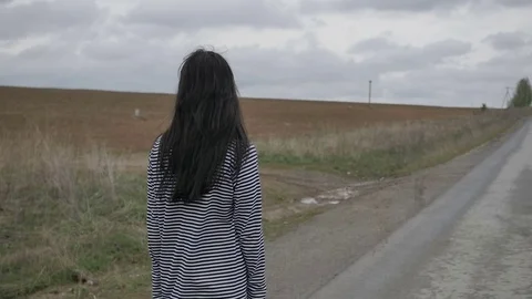 Woman on empty road Видео 75658220