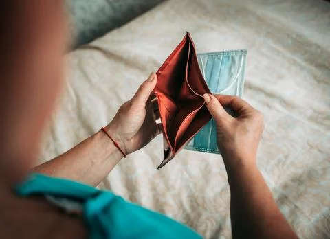 Woman with an empty wallet in her hands. Stock Photos