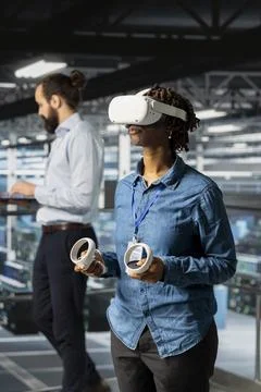 Woman engineer analyzing performance outputs using virtual reality tech Stock Photos