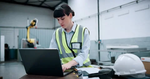 Woman, engineer and document with laptop at warehouse for research, machine Stock Footage 331576797
