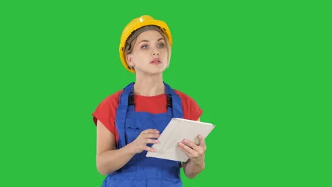 Woman engineer checking building plan on touchpad and looking at objects Stock-Footage 100570619