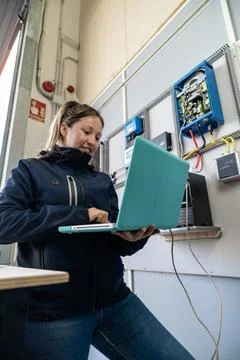 Woman engineer checking solar panel system with laptop Stock Photos
