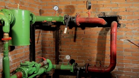 Woman engineer checking technical data of heating system equipment in a boiler 動画素材 76249750