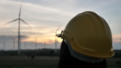 A woman engineer checks the windmill at sunset,Wind farms, workers, Stock Footage 140765341