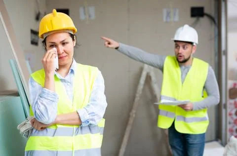 Woman engineer crying because she has been fired by her foreman Stock Photos