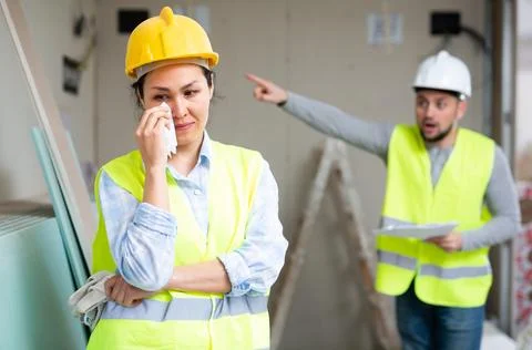 Woman engineer crying because she has been fired by her foreman Stock Photos
