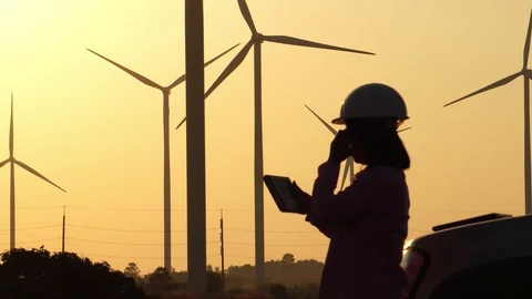 Woman engineer with hard hat against wind turbine Video stock 121237953
