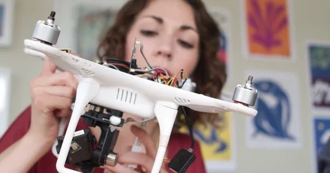 Woman Engineer Looking At The Wiring On The Inside Of An Autonomous Drone In A Stock Footage 82673443