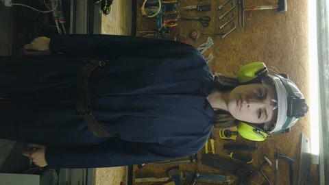 Woman engineer in protective uniform and helmet. Vertical video. Gender equality 스톡 동영상 125261953