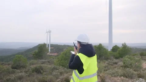 Woman engineer with tablet computer working with wind turbines Video stock 270454250