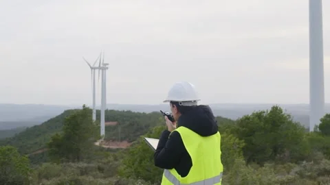 Woman engineer with tablet computer working with wind turbines Video stock 270454259